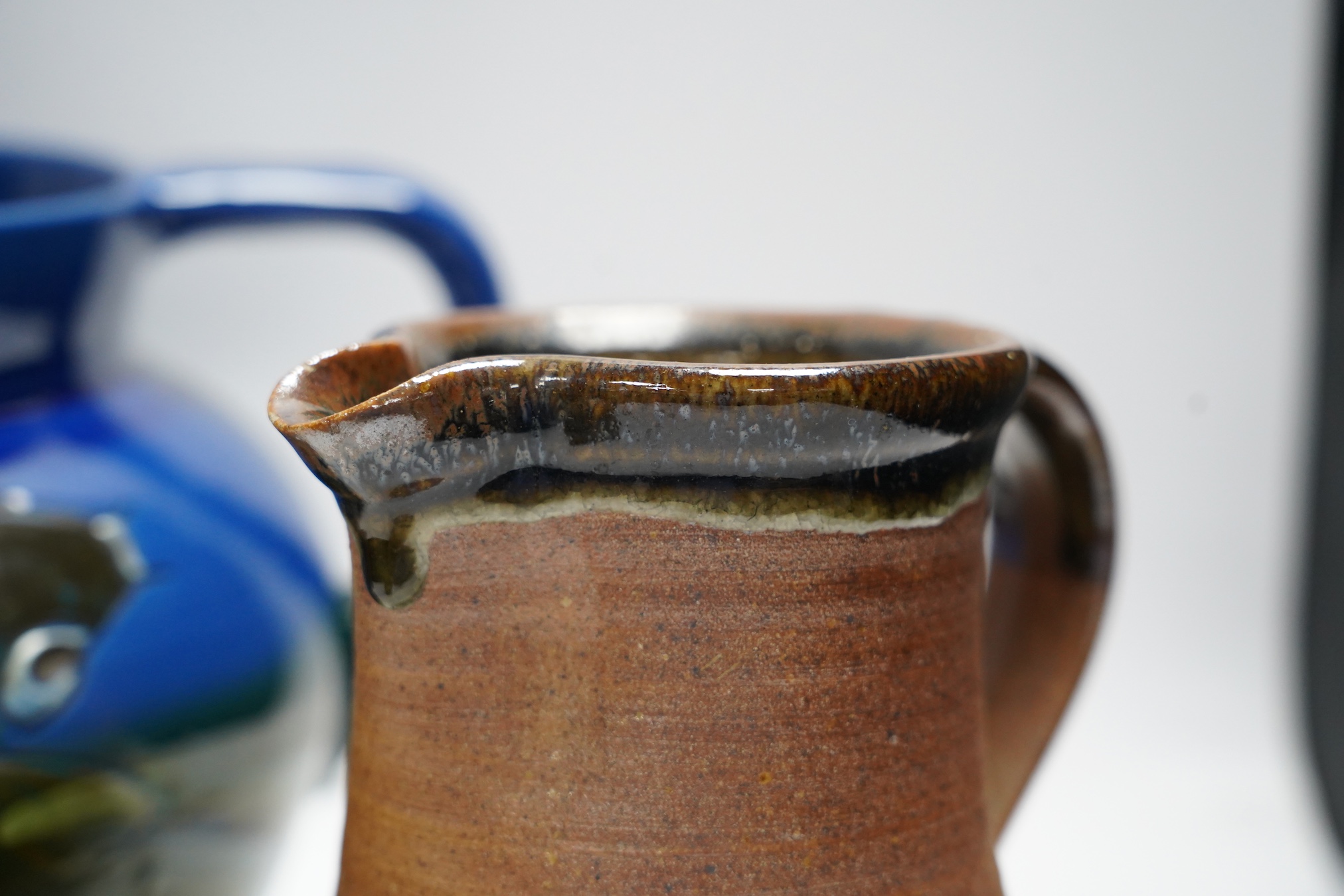 A group of six pottery jugs, to include GH Brannam, Muchelney and Bovey Tracey Art Pottery, largest 20cm high